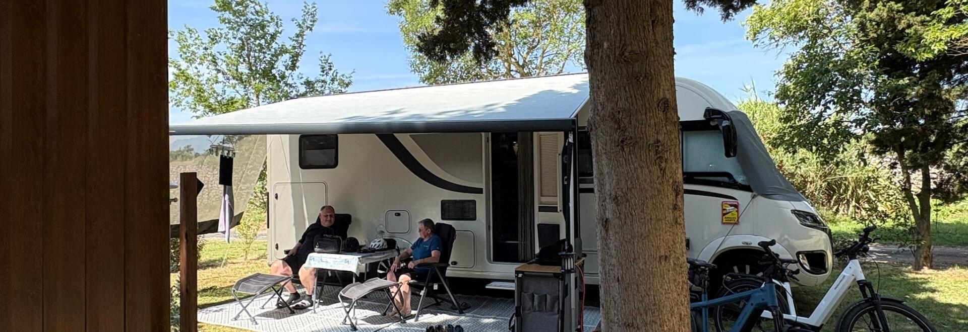 Camping site for a motorhome, located across from a private restroom